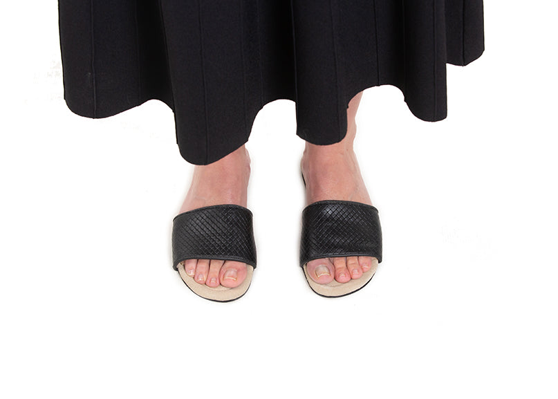 Black woven leather slides